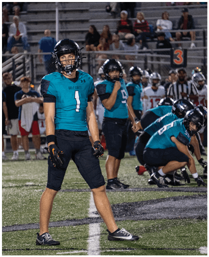 A football player wearing a blue jersey with the number 1 on it. Description generated by AI