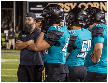 A group of football players on a field. Description generated by AI