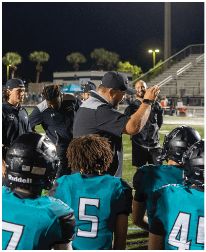 A group of people wearing blue shirts and black helmets. Description generated by AI