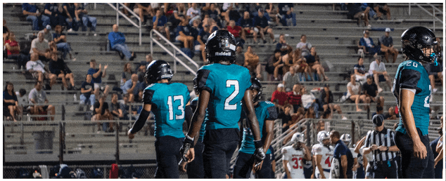 A group of football players on the field. Description generated by AI