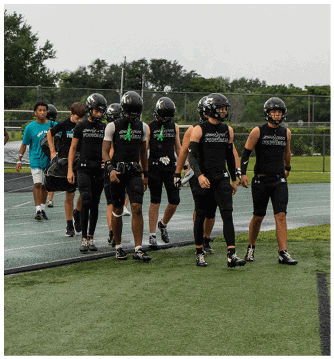 A group of football players walking on the field. Description generated by AI