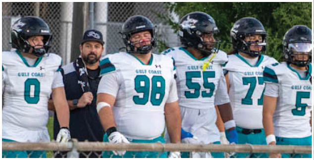 A group of football players on a field. Description generated by AI