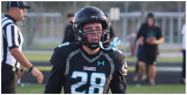 A football player wearing a green jersey with the number 53 on it. Description generated by AI