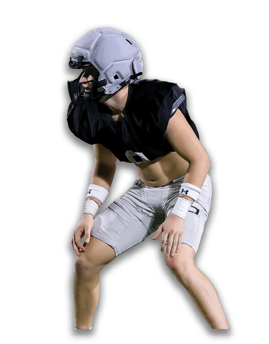 A person wearing athletic shoes, socks, and shorts is standing with legs bent and apart against a white background. Description generated by AI