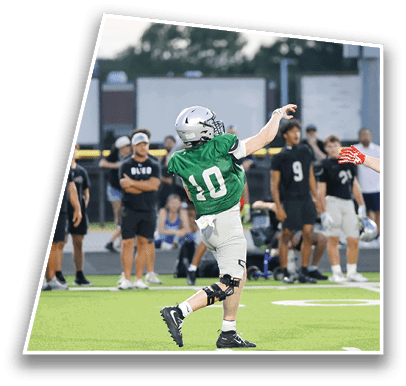 People wearing sports uniforms are playing football on a field with spectators in the background. Description generated by AI