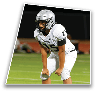 A person in a white football uniform with the number 25 is bent forward in a ready stance on a green field. Description generated by AI