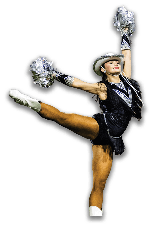 A person wearing a decorative hat and outfit is smiling with arms raised, holding silver pom-poms in a celebratory pose. Description generated by AI