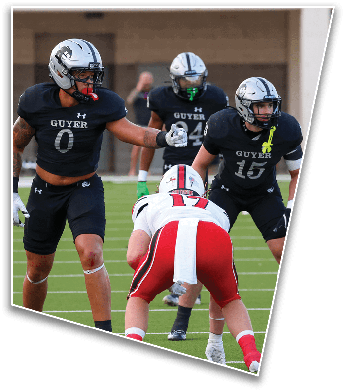 Three people in football uniforms are on a field with one person in a white and red uniform facing two people in black uniforms preparing for a play. Description generated by AI