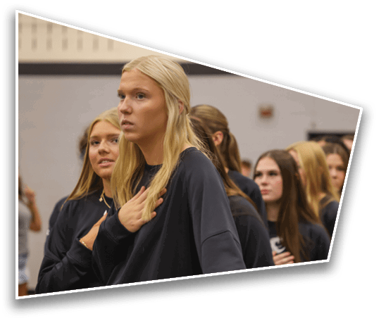 A person with long blonde hair is looking attentively in an indoor setting with a blurred background. Description generated by AI