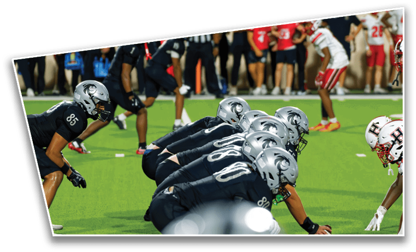 A group of people in football uniforms are lined up on a field facing each other, preparing for a play. Description generated by AI