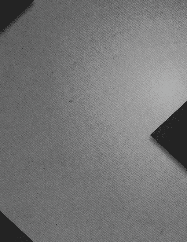 A close-up of a textured surface with two dark rectangular shapes positioned diagonally on opposite corners. Description generated by AI
