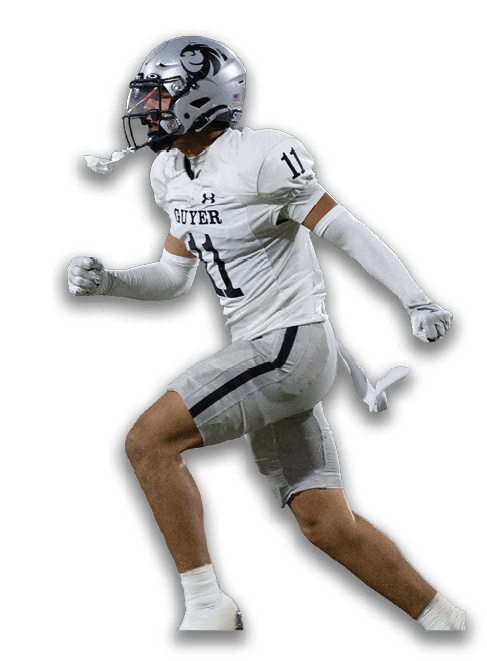 A person wearing a silver football helmet with a black logo and a white sports jersey is looking to the side. Description generated by AI