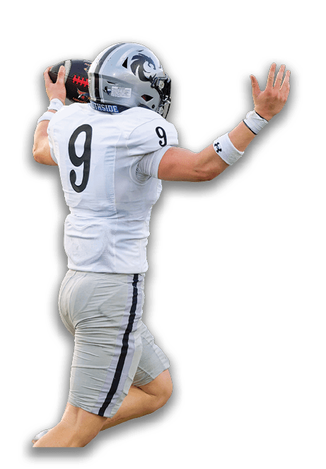 A person wearing a white football uniform with the number nine is holding a football in a throwing position. Description generated by AI