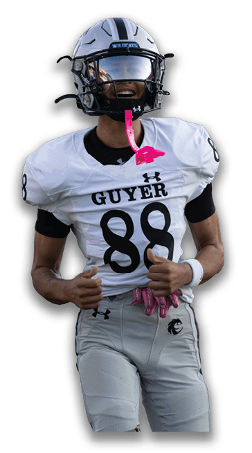 A person wearing a football uniform with the number 88 and the name Guyer is smiling and giving two thumbs up. Description generated by AI