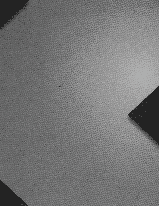 A close-up of a textured surface with two dark rectangular shapes positioned diagonally on opposite corners. Description generated by AI