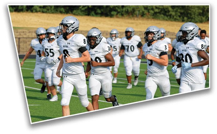 A group of people wearing white football uniforms and helmets are running on a green football field. Description generated by AI