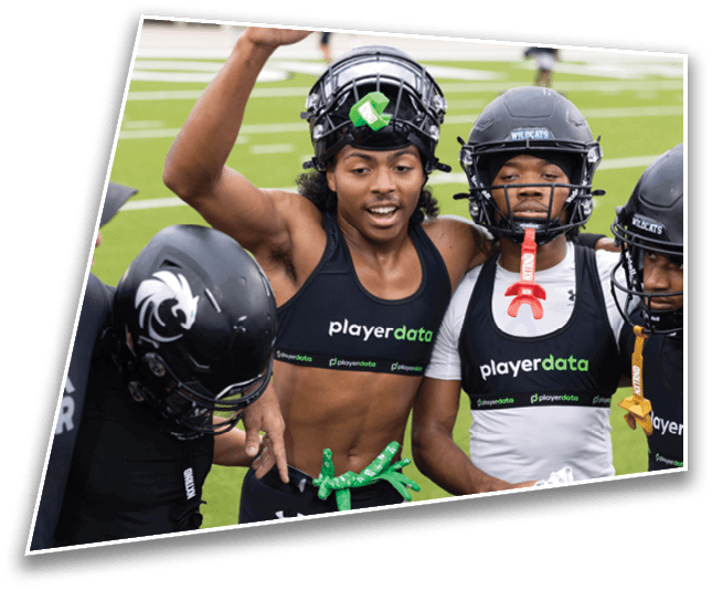 A group of people wearing athletic gear and helmets are gathered closely on a sports field, with some raising their arms and smiling. Description generated by AI