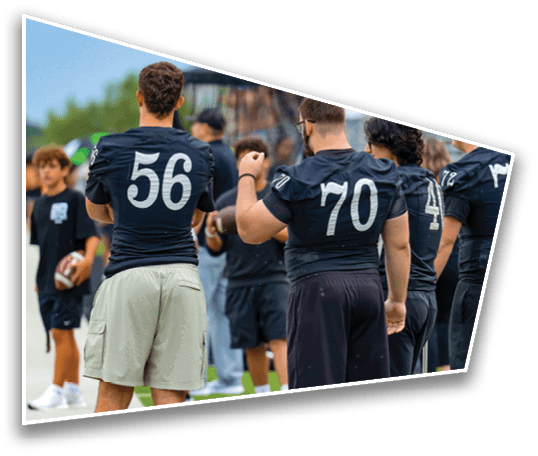 Several people wearing numbered sports jerseys are standing outdoors, with one person holding a football in the background. Description generated by AI