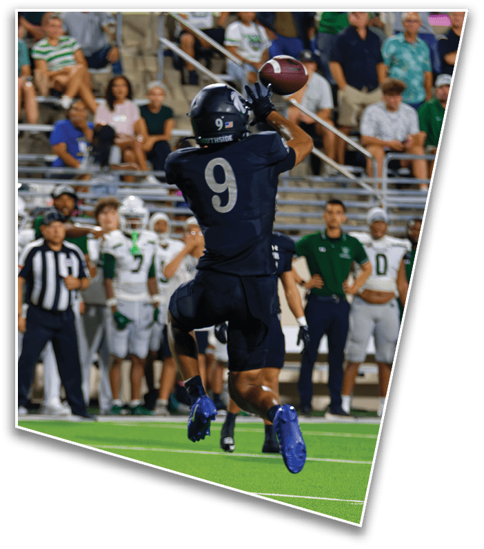 A person wearing a dark sports uniform with the number 9 is jumping on a green football field while several people in white and green uniforms stand in the background. Description generated by AI