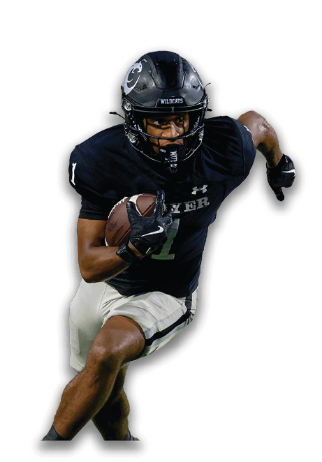 A person wearing a black football uniform and helmet is running while holding a football. Description generated by AI