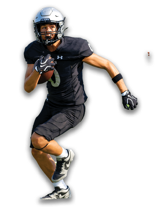 A person wearing a black football uniform is running while holding a football, with another person's hand reaching out toward them. Description generated by AI