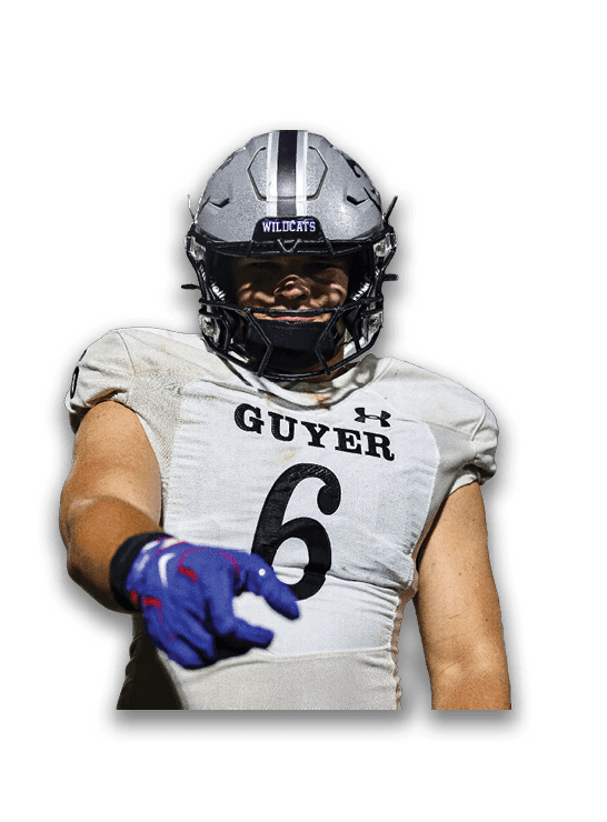 A person wearing a football helmet with the word Wildcats and a white football jersey with the name Guyer and the number 6 is smiling. Description generated by AI