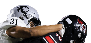 A person in a black and red football uniform is running with the ball while two people in white football uniforms attempt to tackle them on a green field. Description generated by AI