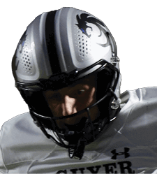 A person wearing a white football uniform with the number 5 is running with the ball while another person in a black uniform attempts to tackle them on a football field. Description generated by AI