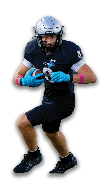 A person wearing a football uniform and helmet is running while holding a football. Description generated by AI