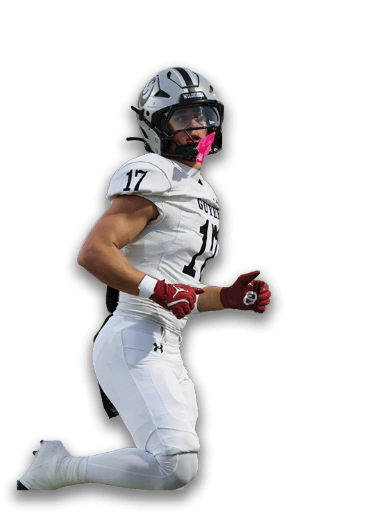 A person wearing a white football uniform with the number 17 is running, with red gloves and white cleats. Description generated by AI