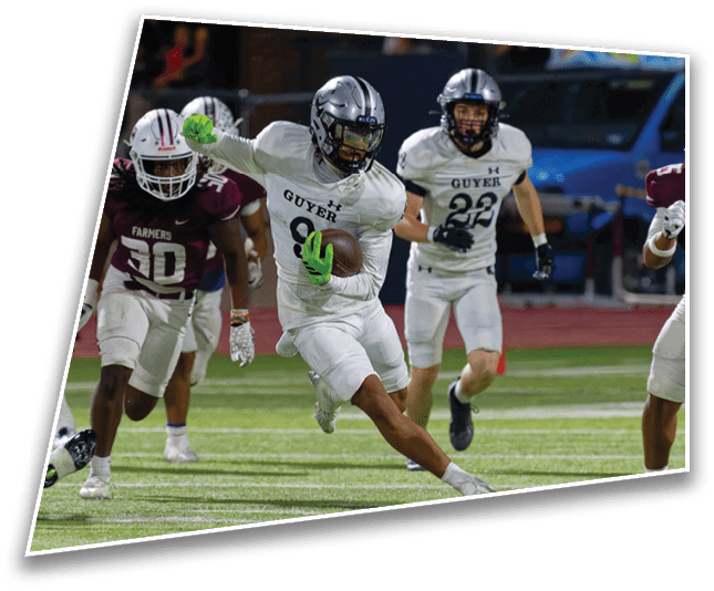 People in football uniforms are actively playing on a field with one person in white running with the ball while others in white and maroon chase. Description generated by AI