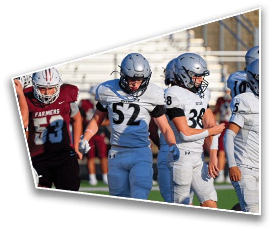 Three people in football uniforms and helmets are walking on a field with one person wearing a maroon jersey and two wearing white jerseys. Description generated by AI