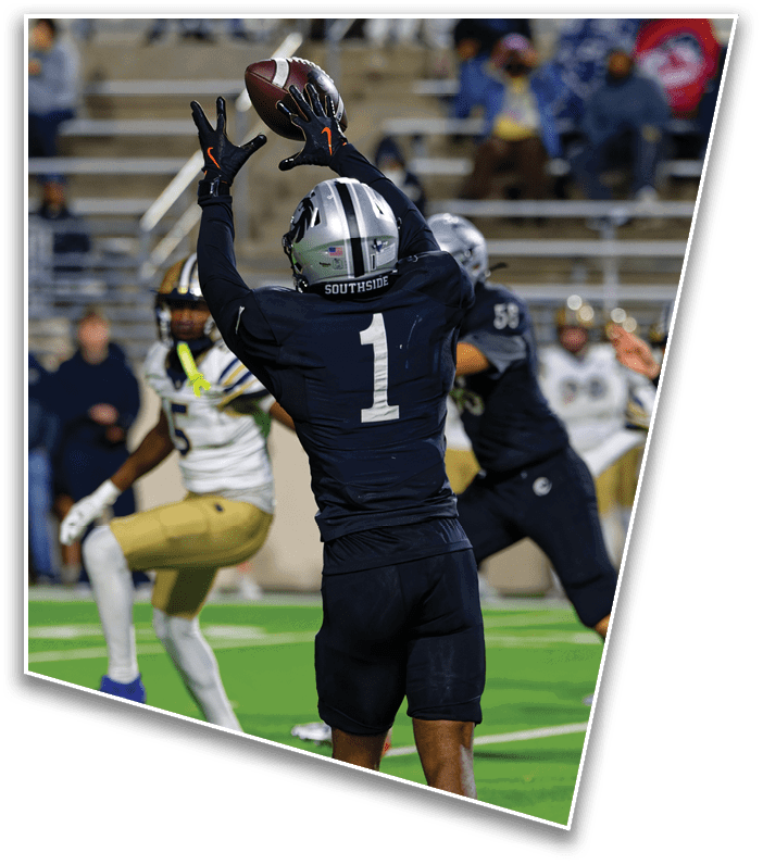 A person wearing a dark football uniform with the number one and a helmet labeled “SOUTHSIDE" is reaching up to catch a football while other players in different uniforms are nearby on a football field. Description generated by AI