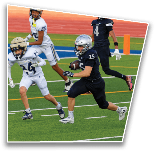 Two people in sports uniforms are running on a green field with white and yellow lines, one wearing black and the other wearing white. Description generated by AI