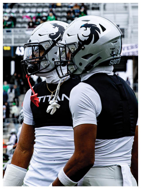 A football player wearing a helmet and jersey with the number 24. Description generated by AI
