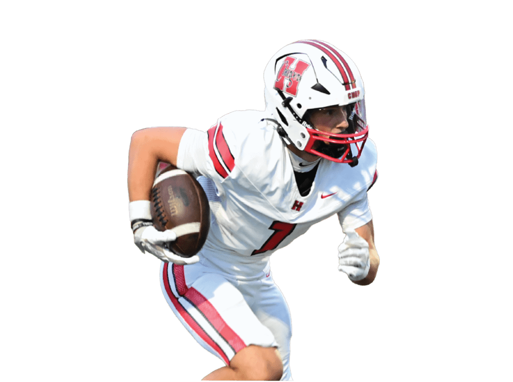 A person wearing a white football uniform with red stripes is running while holding a football. Description generated by AI