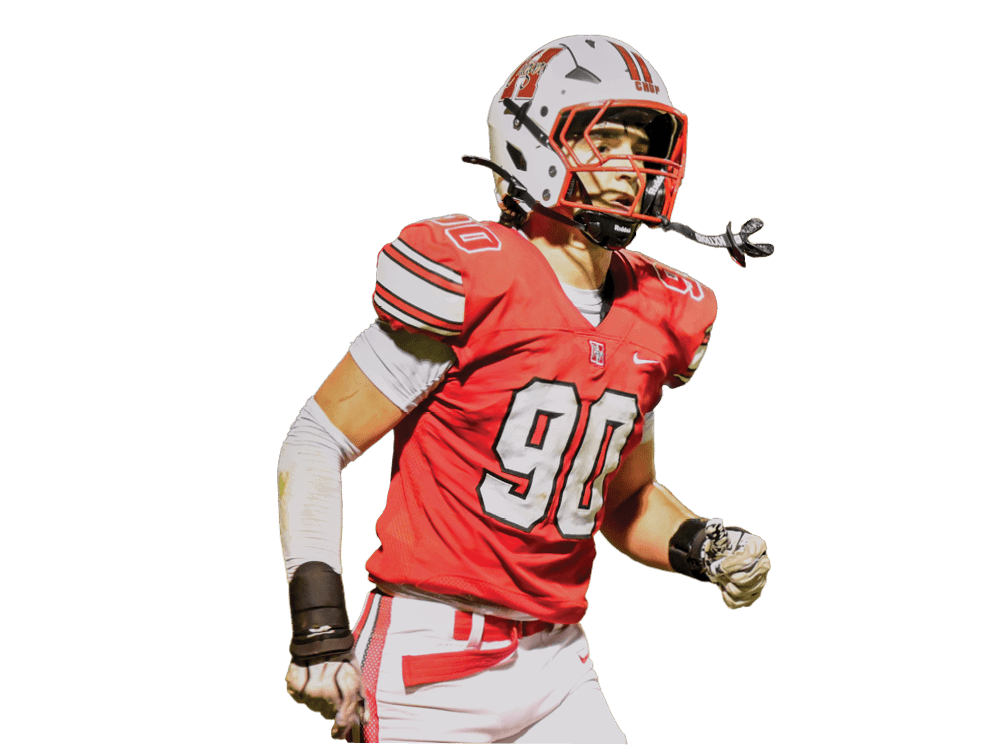 A person wearing a red football uniform and a white helmet with red accents is looking to the side. Description generated by AI
