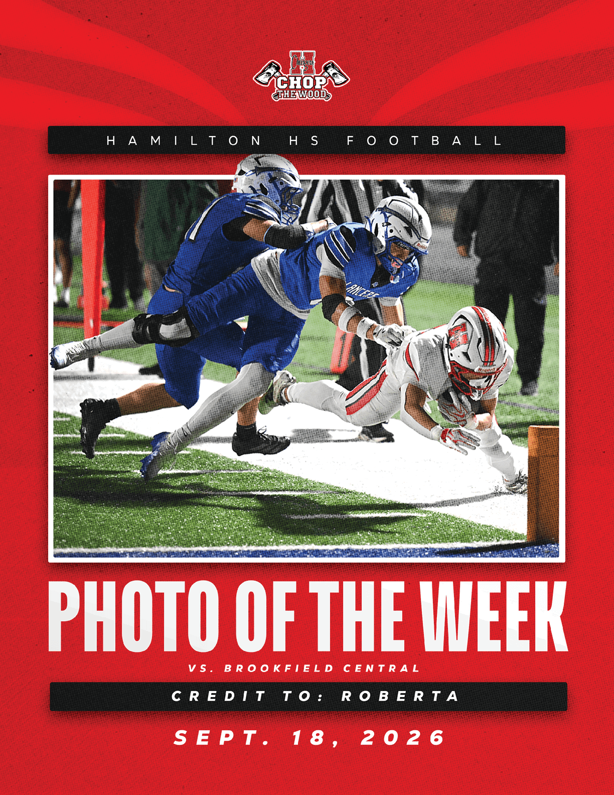 Two football players in blue uniforms tackle a player in a white and red uniform who is diving toward the end zone during a nighttime game. Description generated by AI