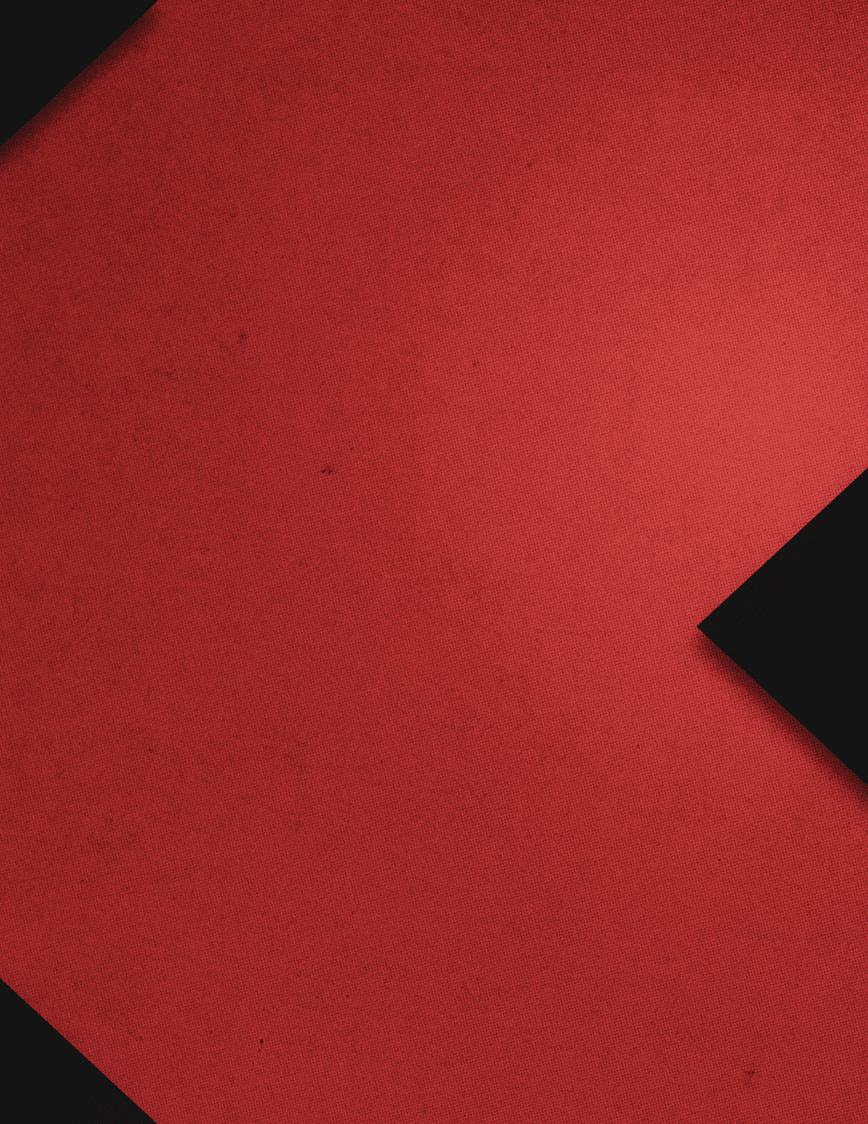 A close-up of a red textured surface with two black angular shapes positioned diagonally on opposite corners. Description generated by AI