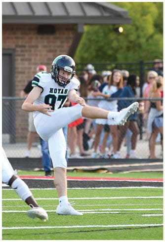 A football player catching a ball. Description generated by AI