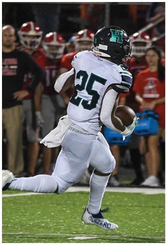 A football player catching a ball. Description generated by AI