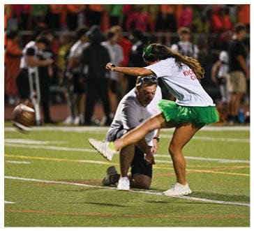 A football player running on the field. Description generated by AI