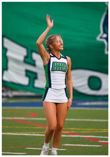A football player running on the field. Description generated by AI