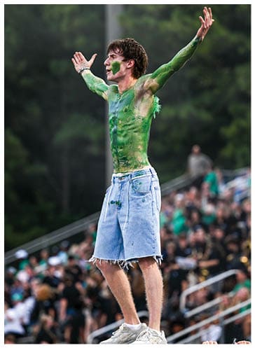 A football player running on the field. Description generated by AI