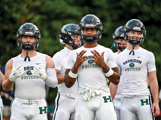 A group of football players in black and white uniforms are on the field. AI generated content