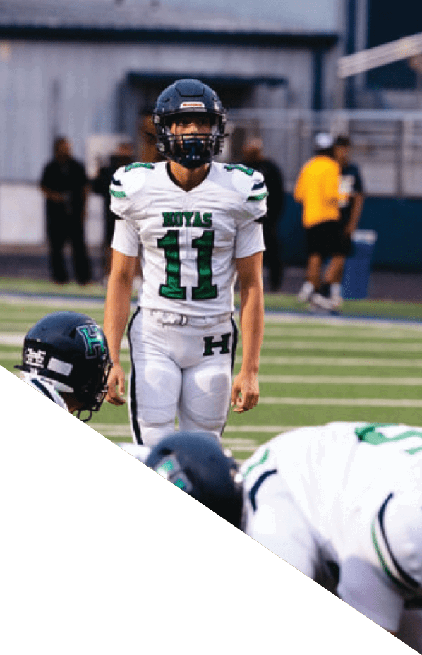 A football player is kneeling on the field, holding his helmet in his hands. AI generated content