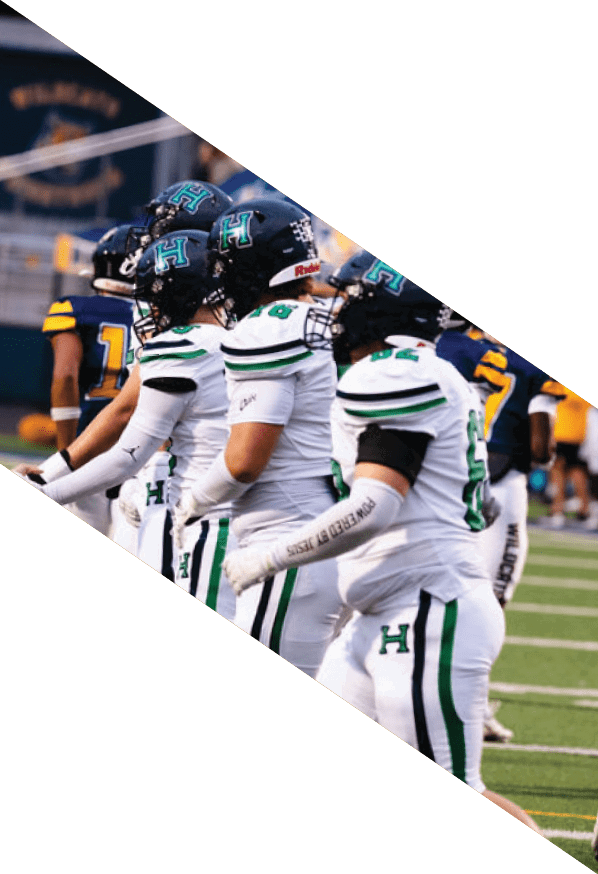 A group of young men wearing black and white uniforms are standing on a field. AI generated content
