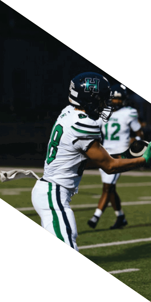 Two men are jumping in the air on a field, both wearing football uniforms. AI generated content