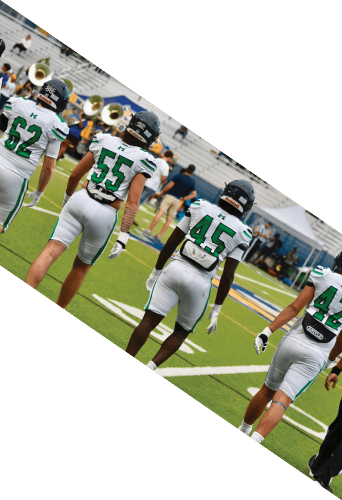 Four football players pose for a picture on the field. AI generated content