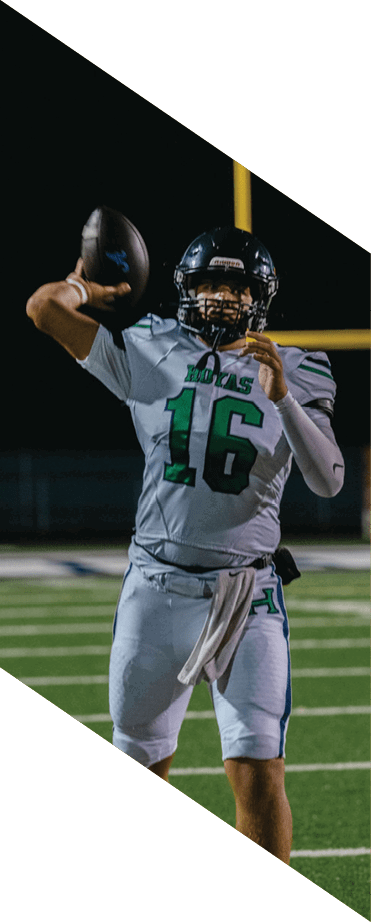 A football player wearing a helmet and white uniform is holding his helmet above his head. AI generated content